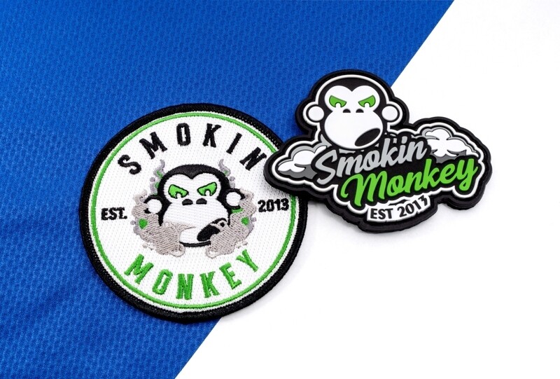 The same logo as a stitched thread patch and as a 3D molded PVC patch, side by side