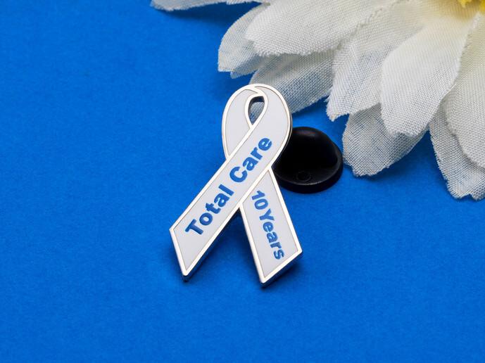 Silk screen Total Care lapel pin