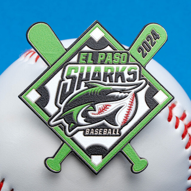 Green and black El Paso Sharks trading pin resting on a baseball